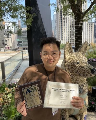 student holding award from ASA